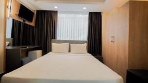 a bedroom with a large white bed with a window at Blue Serenity Hotel in Side