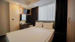 a bedroom with a white bed and a window at Blue Serenity Hotel in Side