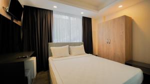 a bedroom with a white bed and a window at Blue Serenity Hotel in Side +29 photos