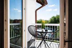 a patio with a table and chairs on a balcony at Hotel Villa Nord Hamburg-Airport in Hamburg