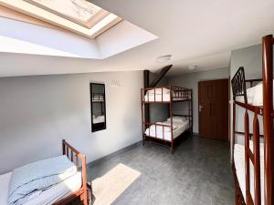 a room with two bunk beds and a skylight at Let's Rock Party Hostel! Age Limit From 18 until 40! in Krakow
