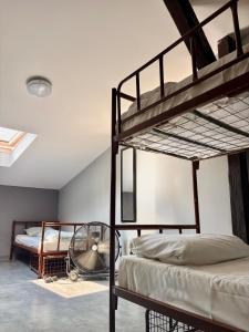 a bedroom with two bunk beds and a fan at Let's Rock Party Hostel! Age Limit From 18 until 40! in Krakow