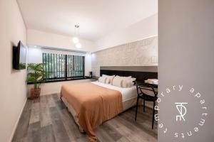 a bedroom with a bed and a desk in it at Top Rentals Montañeses in Buenos Aires +10 photos