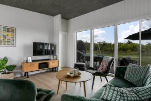 a living room with a couch and chairs and a tv at C11319-Tarm-Multebaervej-33 in Tarm
