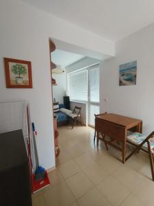 a living room with a table and a couch at SEA SKY View in Byala