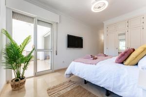 a bedroom with a bed and a tv on a wall at El Rey in Fuengirola +19 photos