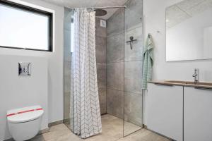 a bathroom with a shower and a toilet and a sink at LF12002-Spottrup-Molleparken-17 in Spottrup +20 photos