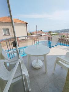 a white table and chairs on a balcony at SEA SKY View in Byala