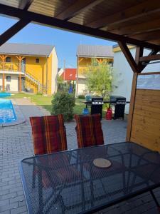 a patio with a table and chairs and a pool at Apartmány Milovice in Milovice