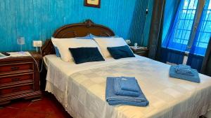a bedroom with a large bed with towels on it at Le Vie del Castello in Francavilla Bisio +21 photos