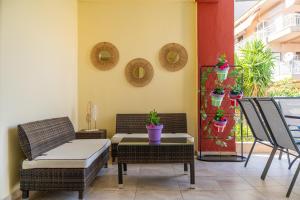a patio with wicker chairs and a table with plants at Kaplanis House in Neos Marmaras +94 photos