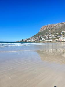 a view of a beach with houses on a hill at Between Mountain and Sea in Cape Town