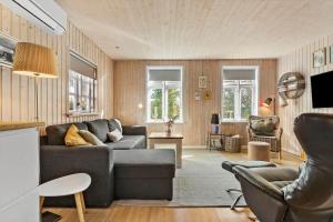 a living room with a couch and a chair at 8566-Grenaa-Askevej-17 in Grenå