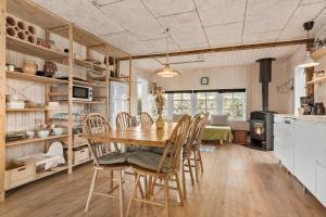 a kitchen and dining room with a table and chairs at 8566-Grenaa-Askevej-17 in Grenå