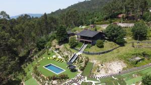 an aerial view of a house on a hill with a pool at Abadia House - Geres in Geres