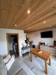 a living room with a couch and a table at charmant studio à Morzine avec piscine privé in Morzine