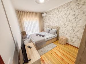 a bedroom with a bed and a tv in it at Abadia House - Geres in Geres +58 photos