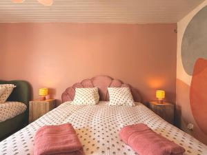 a bedroom with a large bed with two lamps at Les Terres Beaujolaises in Belleville-en-Beaujolais +19 photos