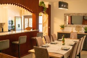 a dining room with a long table and chairs at Abadia House - Geres in Geres