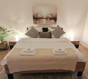 a bedroom with a large bed with two towels on it at Stadtwohnung mit Flair in Recklinghausen
