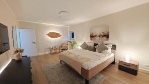a bedroom with a large bed and a living room at Stadtwohnung mit Flair in Recklinghausen