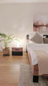 a bedroom with a bed and a potted plant at Stadtwohnung mit Flair in Recklinghausen +19 photos