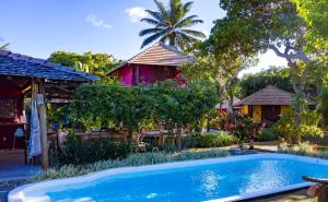 a swimming pool in front of a house at Casa Valentine Pousada Itacaré in Itacaré