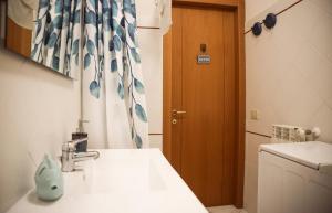 a bathroom with a sink and a shower curtain at Capalbio Relax - Super terrazza in Capalbio +62 photos