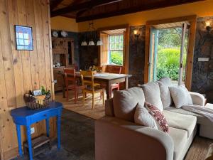 a living room with a couch and a table at Casa da Terra Alta in Santo Amaro