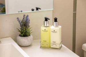 two bottles ofodorizers sitting on a bathroom counter at 1 BR plus Ent District,MTCC,Jays in Toronto