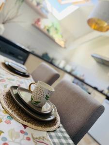 a coffee cup sitting on a plate on a table at Urban Stay Apartment in Aylsham +10 photos