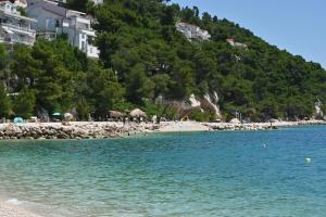 a beach with a group of people in the water at Casa Dalmatia in Krvavica +23 photos
