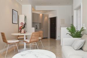 a living room with a couch and a table and chairs at Casa Dalmatia in Krvavica