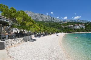 a beach with a group of people in the water at Casa Dalmatia in Krvavica