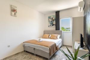 a bedroom with a bed and a window at Vila Martina in Novalja +80 photos