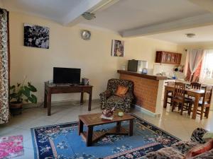 a living room with a couch and a table at IVATO Airport STUDIOS CHAMBRES in Ivato