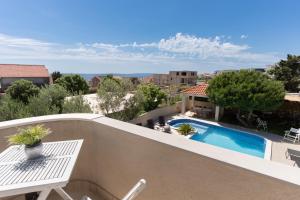 a view of a swimming pool from the balcony of a house at Vila Martina in Novalja