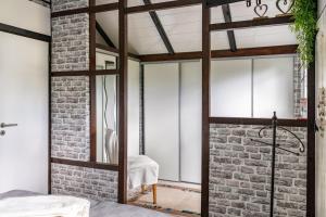 a room with a brick wall and a glass door at Elfenwinkel am See in Gartow +35 photos