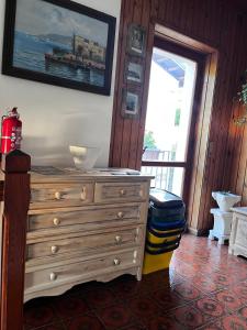 a room with a dresser with a picture on the wall at A due passi dai lupi in Civitella Alfedena +31 photos