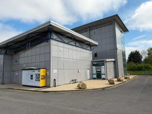 a large white building with a yellow gas station at CoStays Aparthotel - Middlesbrough in Middlesbrough