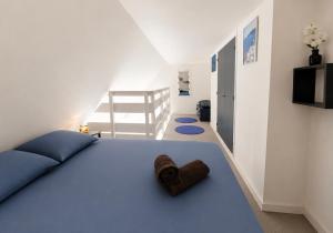 a room with a bed with a brown towel on it at Duplex vue mer, balcon, parking privé in Cabourg