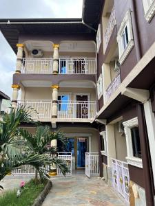 a large building with balconies and a courtyard at Esthemers Royal Hotel in Brunkum
