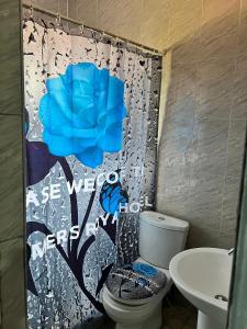 a bathroom with a toilet and a shower curtain at Esthemers Royal Hotel in Brunkum +15 photos