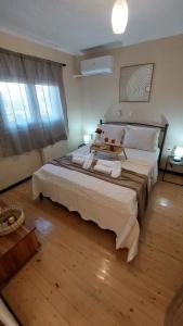 a bedroom with a large bed with a wooden floor at The Mastiha Spot 8 in Chios