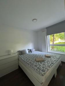 a bedroom with a large bed with a window at Cube Apartamenty in Lublin