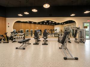 a gym with a lot of treadmills and machines at SeaStays Apartments in Miami Beach +10 photos