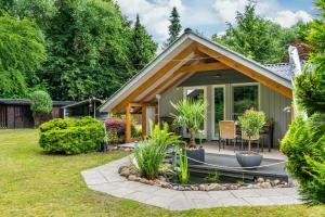 a small green house with a patio and plants at Elfenwinkel am See in Gartow
