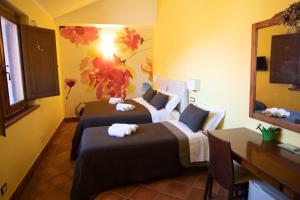 a hotel room with two beds and a desk at Tenuta Terre dei Latini in Segni +50 photos