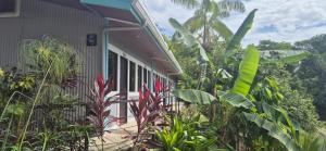 a house with a bunch of plants in front of it at Senda Adults Only Hostel in Manuel Antonio