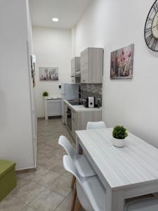 a kitchen with a table and chairs in a room at Da Silvi Apartment in Terracina